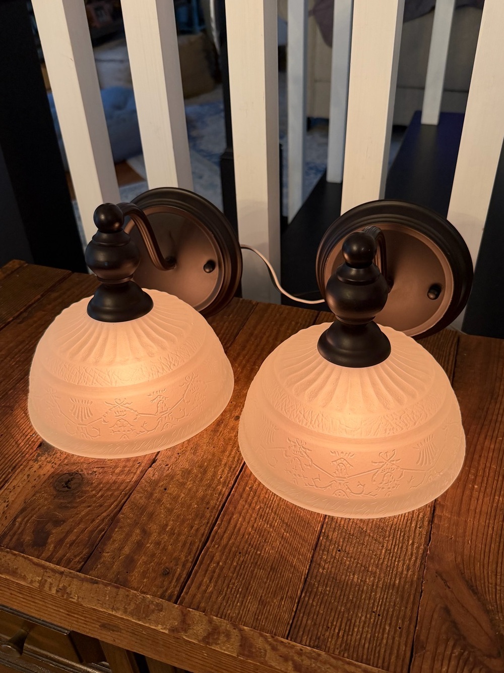 Pair of traditional wall sconces dark bronze fixtures and frosted pattern glass